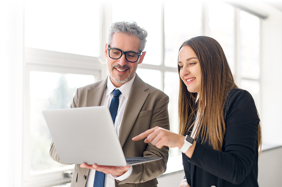 YoungFemaleProfessionalPointsToScreenOfALaptopWhile Training Progress Team-Work-900px Case Studies